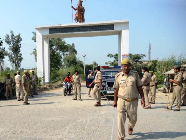 Policemen keep a vigil at the entrance of Bishara Village in Dadri where a man was lynched by a mob for allegedly eating beef