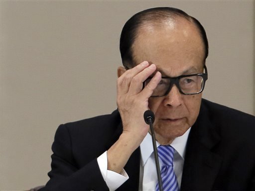 Hong Kong tycoon Li Ka-shing reacts during a press conference in Hong Kong. Hong Kong billionaire Li has defended his business strategy against criticism in China's state media that accused him of abandoning the cou