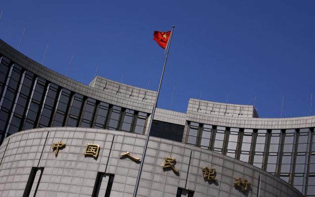 A Chinese national flag flutters outside the headquarters of the People's Bank of China the Chinese central bank in Beijing. File