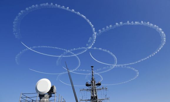 Blue Impulse jets of the Japan Air Self Defense Force’s aerobatic team fly over during the official triennial Maritime Self Defense Force fleet review in the waters off Sagami Bay