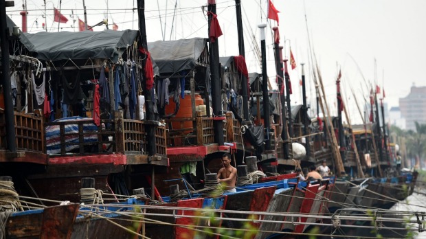 Boats berth in Xingang harbour in Haikou capital of south China's Hainan Province as fierce winds batter the region