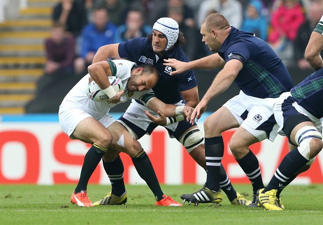 South Africa's Fourie Du Preez is tackled by Scotland’s Blair Cowan during their Rugby World Cup Pool B match between Scotland and South Africa at St James Park Newcastle England Saturday Oct. 3 2015