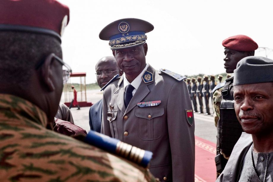 Burkina Faso coup leader Gen. Gilbert Diendere center greets people at the airport during the arrival of Niger's President Mahamadou Issoufou for talks in Ouagadougou Burkina Faso. Burkina Faso's army