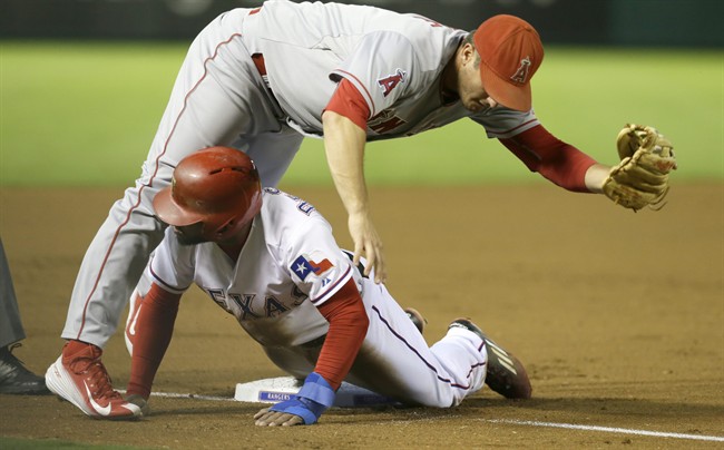 Texas Rangers Delino DeShields bottom slides under third base against Los Angeles Angels third baseman David Freese after De Shields was tagged out trying to steal during the first inning of a baseball game in Arlington Texas Friday Oct. 2 2015