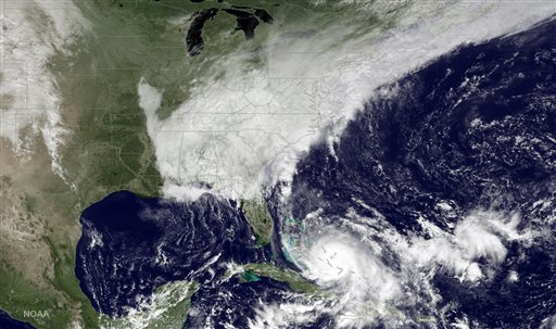 This satellite image taken Friday Oct. 2 2015 at 12:45 p.m. EDT and released by the National Oceanic and Atmospheric Administration, shows Hurricane Joaquin bottom center pounding the Bahamas and a deepening low pressure system on the U.S. eas