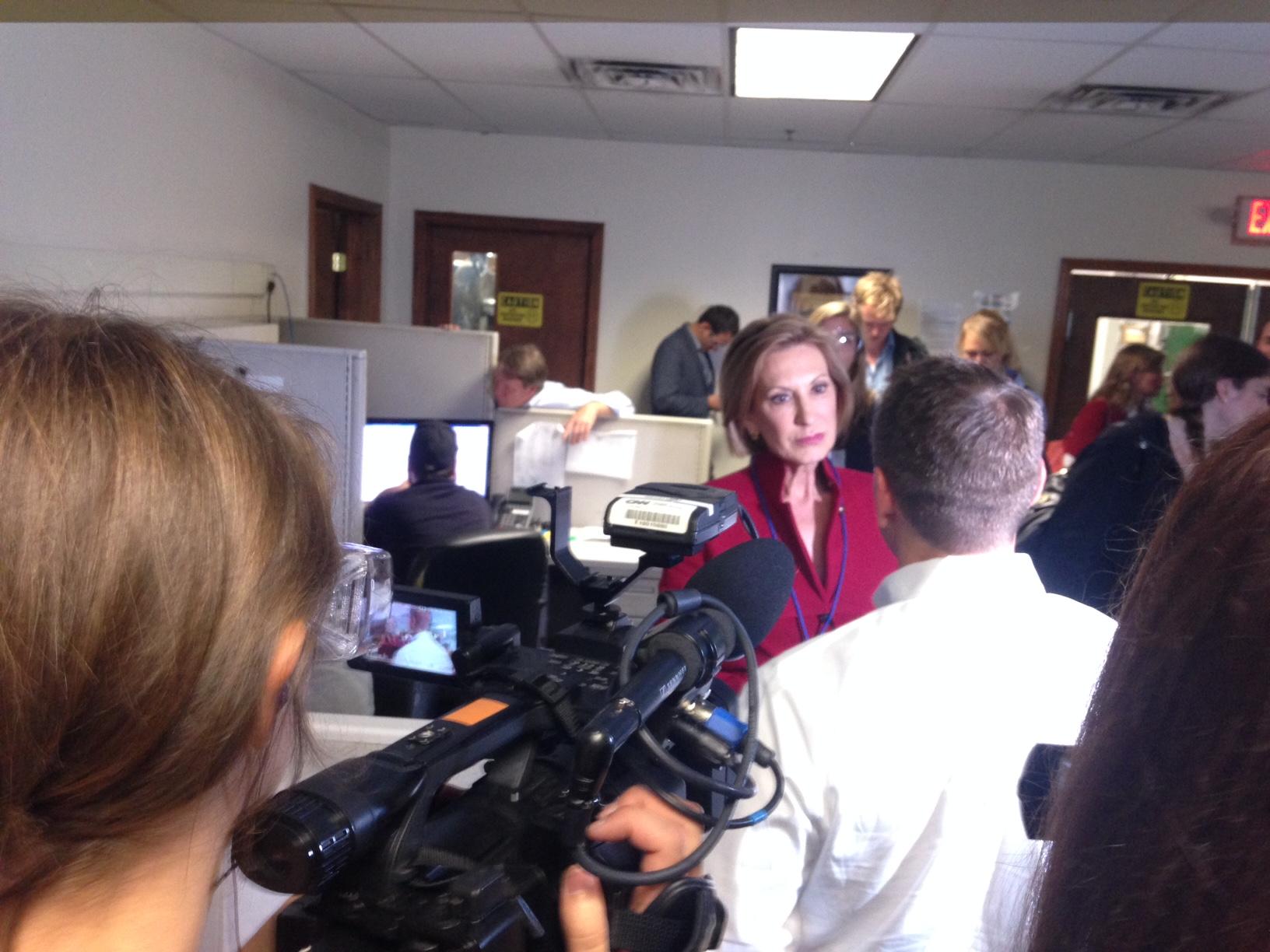 Carly Fiorina is trailed by reporters on her tour of Rapid Sheet Metal in Nashua NH