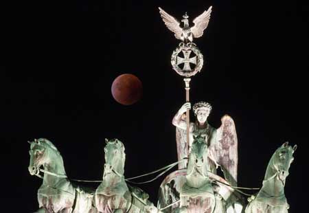 RARE EVENTA so-called ‘blood moon’ can be seen behind the Quadriga sculpture on top of Berlin’s landmark the Brandenburg Gate during a total lunar eclipse on Monday. AFP