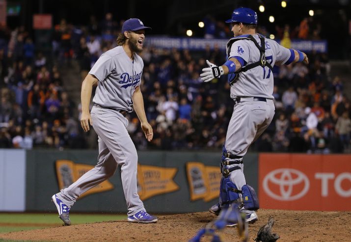 Los Angeles Dodgers pitcher Clayton Kershaw left celebrates with catcher A.J. Ellis after beating the San Francisco Giants in a baseball game in San Francisco Tuesday Sept. 29 2015. The Dodgers won 8-0 to clinch the National League West division