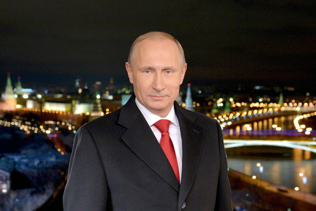 Russian President Vladimir Putin stands during a TV address to the nation