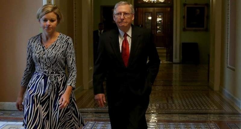 Senate Majority Leader Mitch Mc Connell walks with an aide as he leaves the Senate Chamber after a vote to avert a government shutdown on Capitol Hill on Sept. 30 2015 in Washington DC