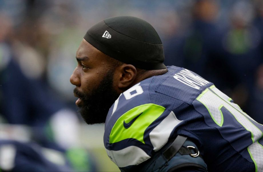 Seattle Seahawks tackle Russell Okung stretches on the field before an NFL football game against the Carolina Panthers Sunday Oct. 18 2015 in Seattle