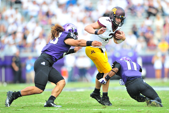 FORT WORTH TX- SEPTEMBER 13 Mitch Leidner #7 of the Minnesota Golden Gophers is brought down by Mike Tuaua #93 and Ranthony Texada #11 of the TCU Horned Frogs