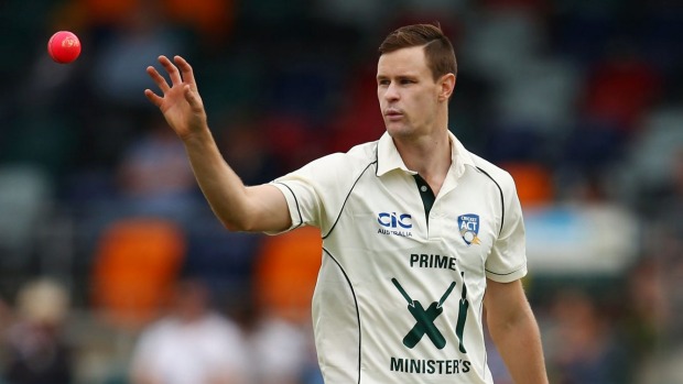 Australian Jason Behrendorff of the Prime Minister's XI prepares to bowl with the pink ball during the tour match against New Zealand