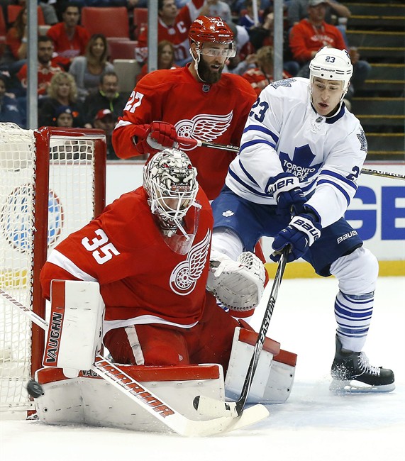 Detroit Red Wings goalie Jimmy Howard stops a Toronto Maple Leafs center Shawn Matthias shot as defenseman Kyle Quincey defends in the first period of an NHL hockey game in Detroit Friday Oct. 9 2015