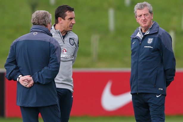 England manager Roy Hodgson speaks with coach Gary Neville and assistant manager Ray Lewington