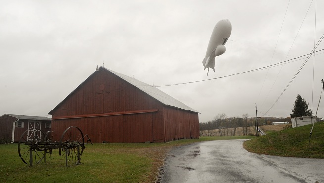 An unmanned Army surveillance blimp floats through the air while dragging a tether line south of Millville Pa. Wednesday Oct. 28 2015