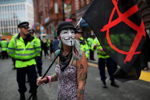 Anti-austerity protesters gather outside Manchester Central during on the second day of the Conservative party conference