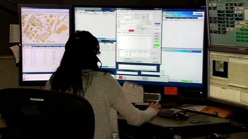 FILE- A woman is seen taking calls at an emergency call center in this undated image