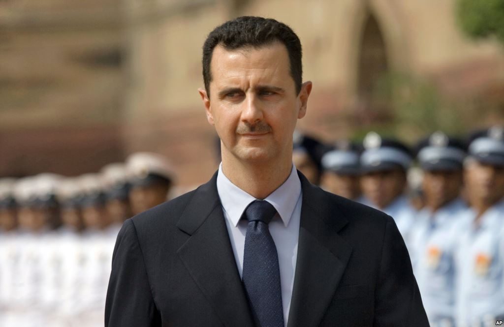 FILE- Syrian President Bashar al Assad inspects a guard of honor at the Presidential Palace in New Delhi India