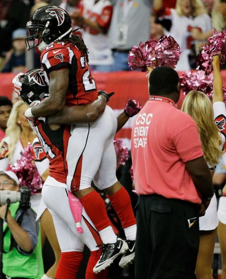 Atlanta Falcons running back Devonta Freeman celebrates his touchdown with Atlanta Falcons wide receiver Roddy White against the Houston Texans during the first half of an NFL football game Sunday Oct. 4 2015 in Atlanta