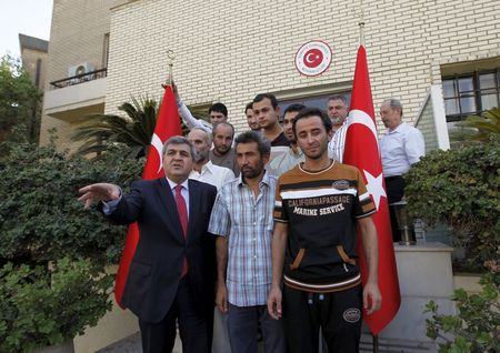 Faruk Kaymakci the Turkish ambassador to Iraq and Turkish workers stand in front of the Turkish embassy in Baghdad Iraq