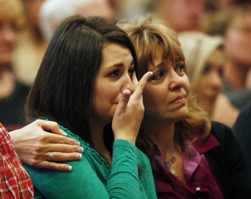 Lacey Scroggins left is comforted by her mother