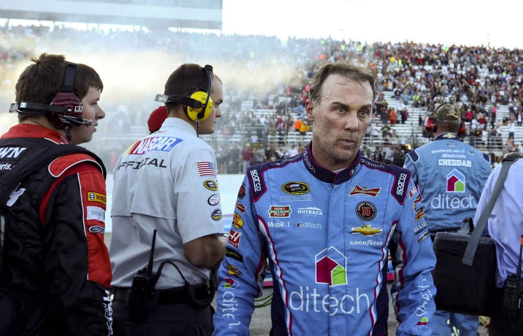 Smoke from Matt Kenseth's victory burnout hangs in the air behind Kevin Harvick as Harvick leaves the pit area after Sunday's NASCAR Sprint Cup race at New Hampshire Motor Speedway in Loudon N.H. Harvick who was in the lead ran out of gas near the end