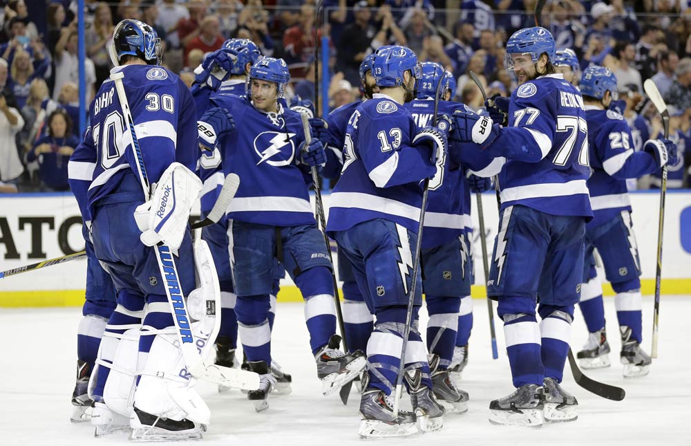 Members of the Tampa Bay Lightning celebrate after defeating the Montreal Canadiens 4-1 during Game 6 of a second-round NHL Stanley Cup hockey playoff series