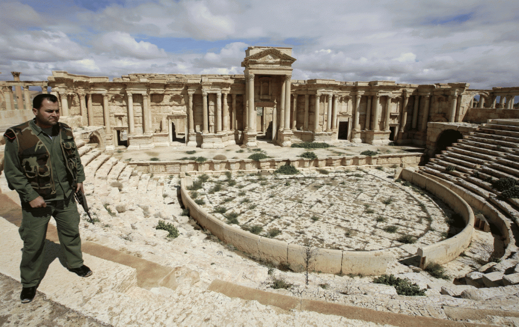 A Syrian policeman patrols the amphitheatre in Palmyra in March 2014 before it was taken over by Isis