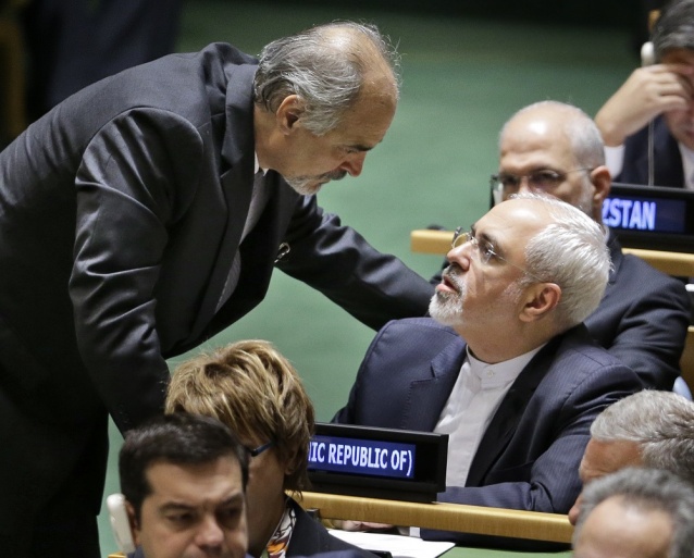 Syrian Ambassador to the United Nations Bashar Jaafari left talks with Iran's Foreign Minister Mohammad Javad Zarif during the 70th session of the United Nations General Assembly at U.N. headquarters Sept. 28