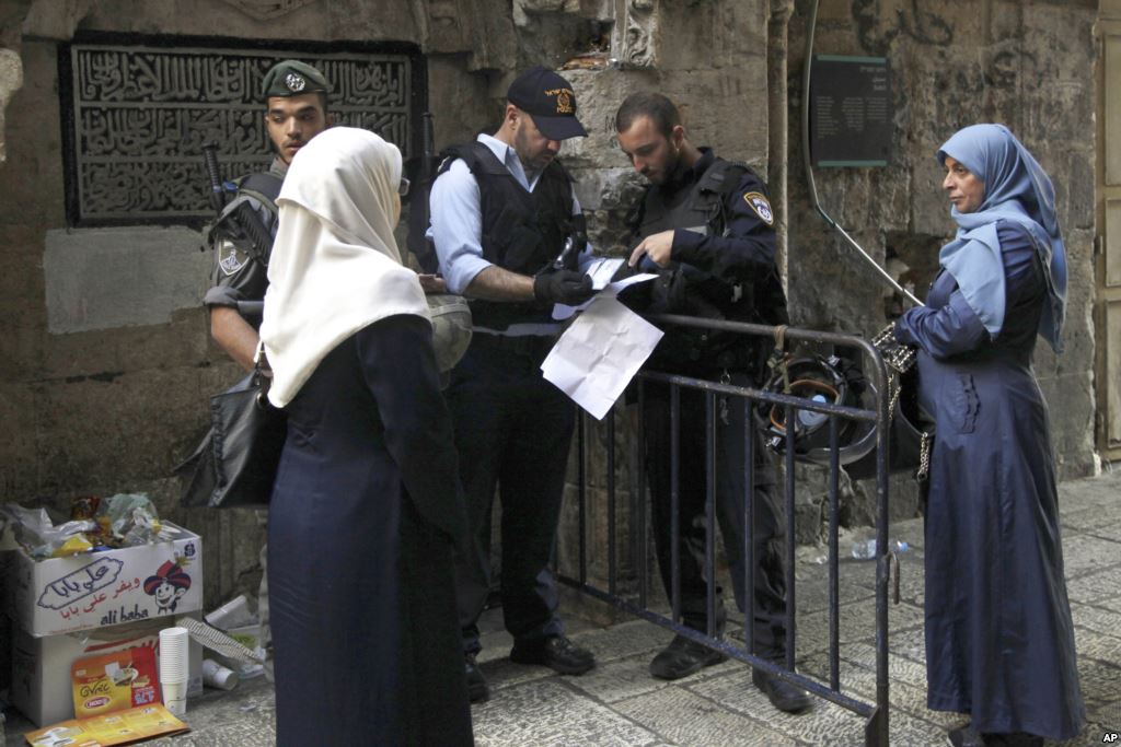 Israeli police check the papers of a Palestinian woman in Jerusalem's Old City Oct. 8 2015. Tensions have gripped the country for weeks