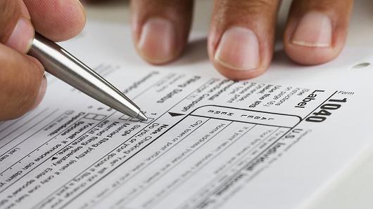 Man filling out income tax form