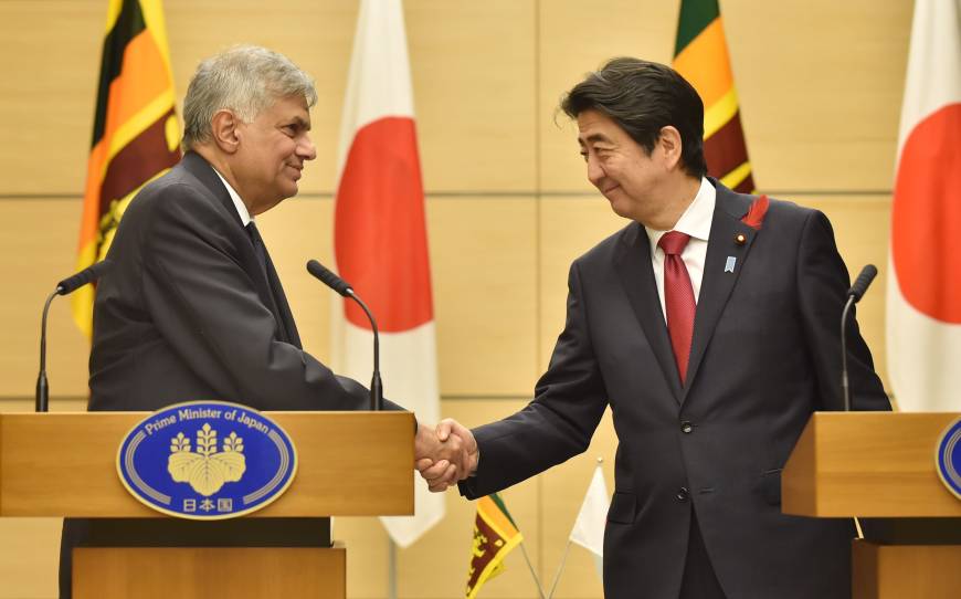 Sri Lankan Prime Minister Ranil Wickremesinghe and Prime Minister Shinzo Abe shake hands following a joint news conference in Abe's office in Tokyo on Tuesday. | AFP-JIJI