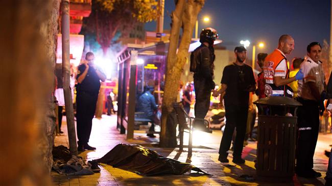 Israeli security forces stand next to the body of a Palestinian man after shooting him dead near al Quds central bus station