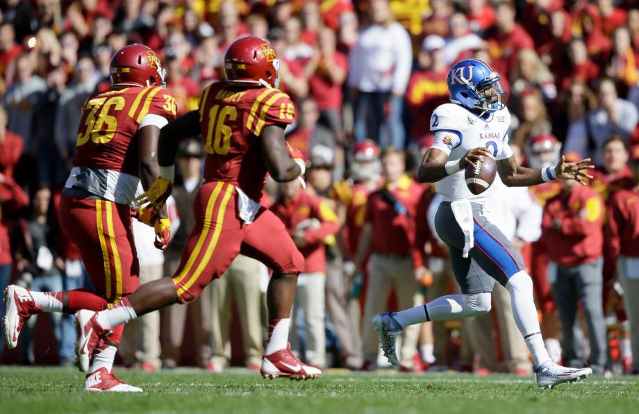 Kansas quarterback Montell Cozart right runs from Iowa State defenders Bobby Leath and Willie Harvey during the first half of an NCAA college football game Saturday Oct. 3 2015 in Ames Iowa. Iowa State won 38-13