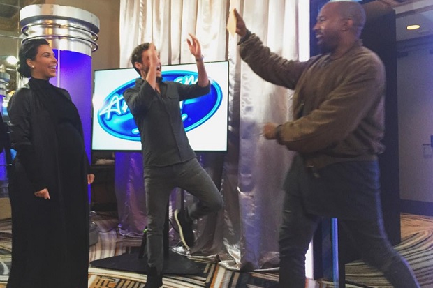 Kanye West high fiving Ryan Seacrest after sailing to the next round of American Idols