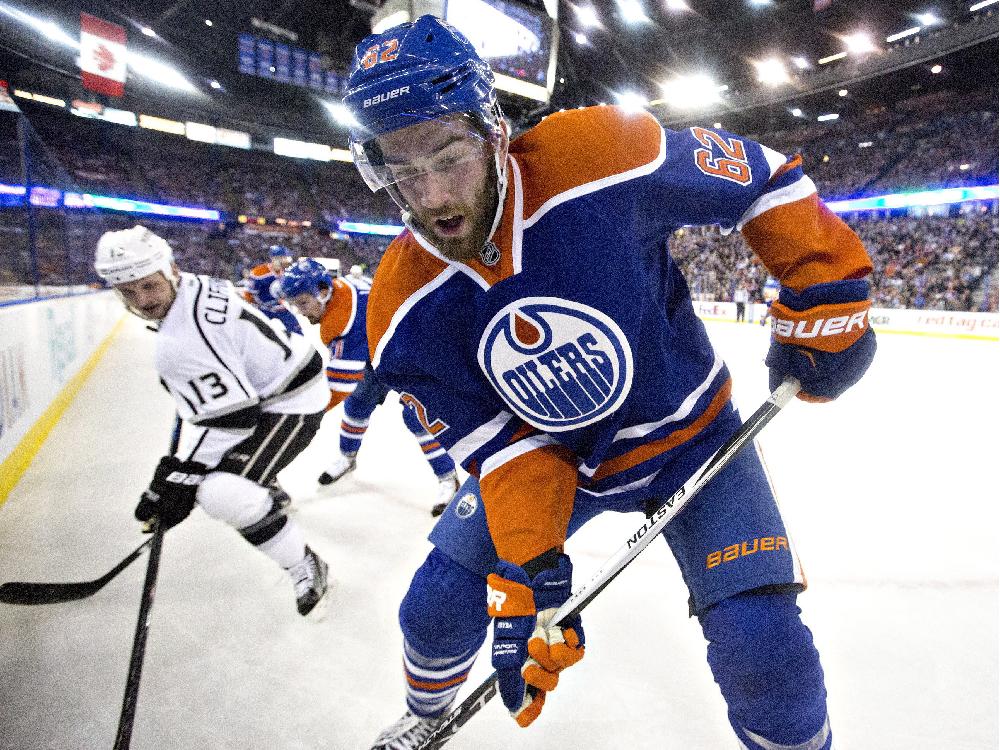 Los Angeles Kings&#039 Kyle Clifford left chases Edmonton Oilers&#039 Eric Gryba during first-period NHL action at Rexall Place on Sunday