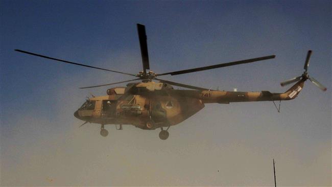 An Afghan helicopter carrying security personnel arrives at the scene of an offensive against Taliban militants in the strategic northern city of Kunduz