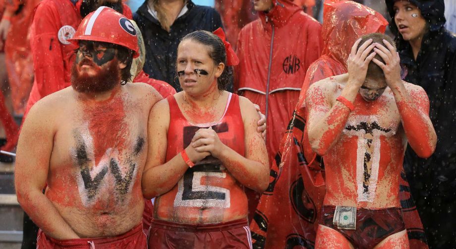 Georgia fans sporting the letters W-E-T in the pouring rain react as Alabama scores a touchdown during an NCAA college football game Saturday Oct. 3 2015 in Athens Ga.  MARIETTA DAILY OUT GWINNE