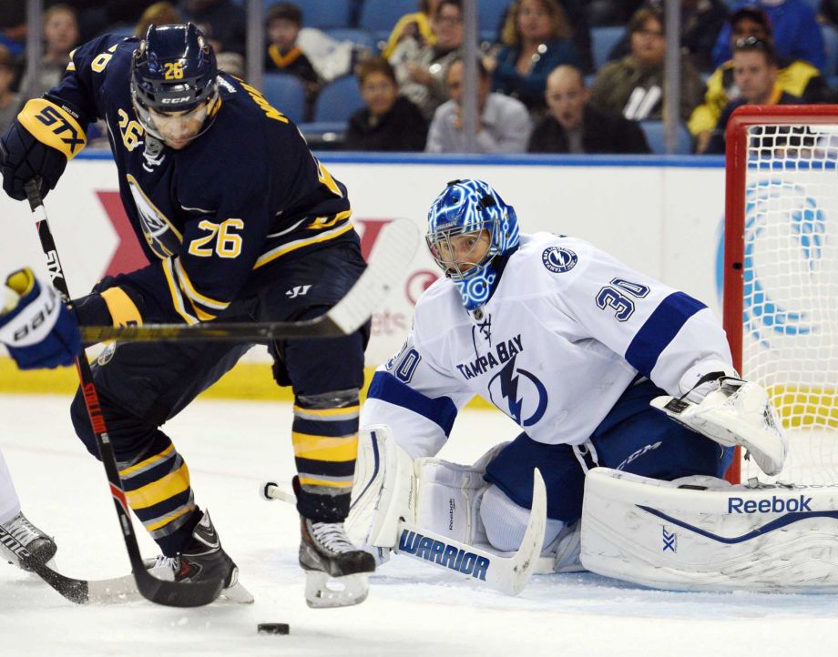 Buffalo Sabres left winger Matt Moulson battles for a loose puck in front of Tampa Bay Lightning goaltender Ben Bishop during the third period of an NHL hockey game Saturday Oct. 10 2015 in Buffalo N.Y. Tampa Bay won 4-1