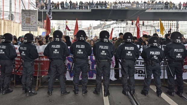 Police secure the streets during a counter demonstration against far-right groups in Cologne on Sunday