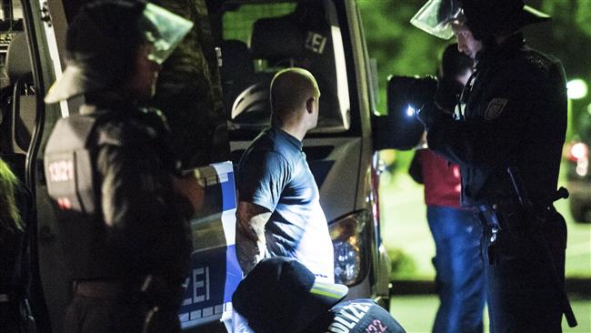 German police check the identity of a person after an assembly ban near an accommodation for asylum seekers in the town of Heidenau eastern Germany