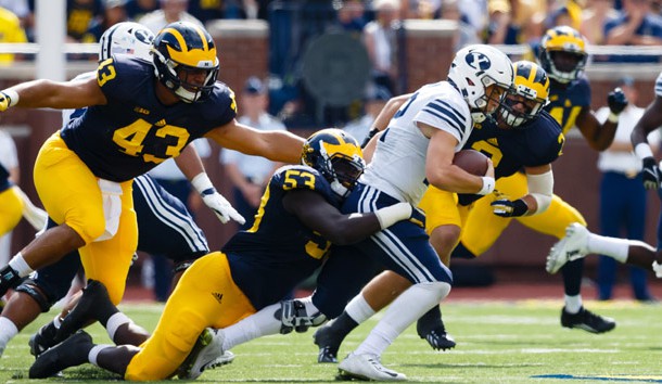 Sep 26 2015 Ann Arbor MI USA Brigham Young Cougars quarterback Tanner Mangum is tackled by Michigan Wolverines defensive end Mario Ojemudia in the third quarter at Michigan Stadium. Michigan won 31-0. Mandatory Credit Rick Osentoski-USA TO