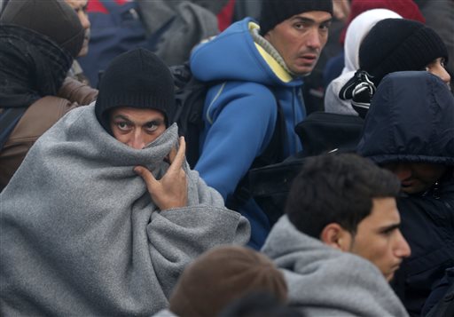 Migrants wait to cross a border between Serbia and Croatia near the village of Berkasovo Serbia Thursday Oct. 22 2015. Many migrants from the Middle East Asia and Africa expressed bewilderment and disappointment because they had been told as they