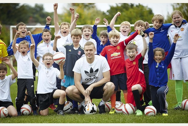 Stoke skipper Ryan Shawcross takes a training session at Sound and District Primary School near Nantwich. His two eldest children are pupils at the school