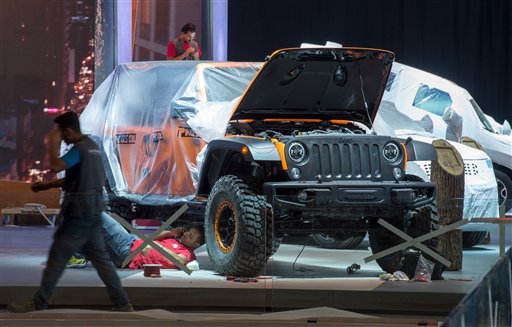 A Jeep is still hidden under plastic foil at the exhibition grounds of the International Motor Show IAA in Frankfurt Germany Sunday 13 Sept. 2015. The car show ran from Sept 17 to Sept 27 2015