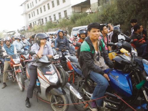 Nepalis adapt to fuel shortage by carpooling riding bikes