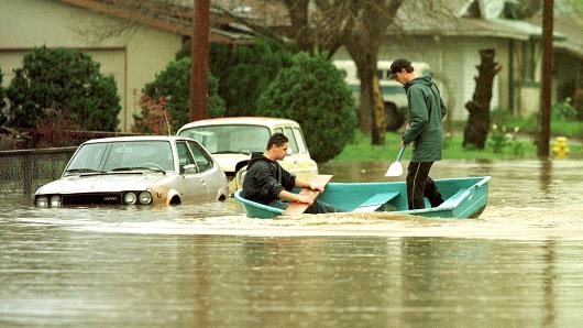 Residents paddle through their neighborhood street in Petaluma California on Feb. 19 2015