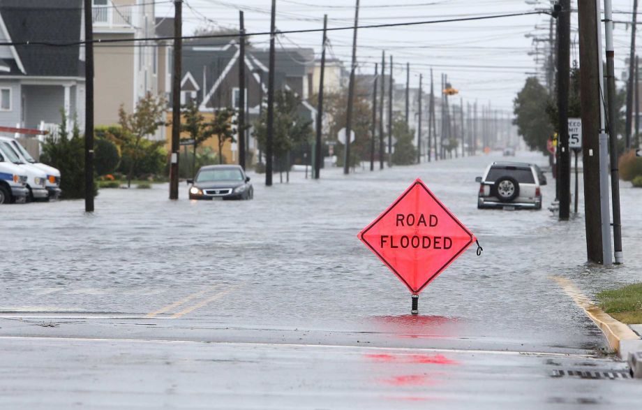 A car is stuck in floodwaters along Central Avenue in Sea Isle City N.J. Friday Oct. 2 2015. New Jersey got pounded Friday by heavy rain and strong winds that were expected to bring coastal flooding this weekend even though the state is no longer