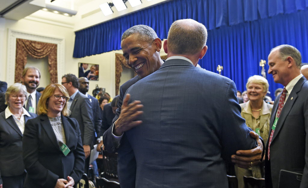 President Obama hugs Illinois Senate President Pro Tempore Don Harmon as he meets with state legislators at the White House on Sept. 30 2015